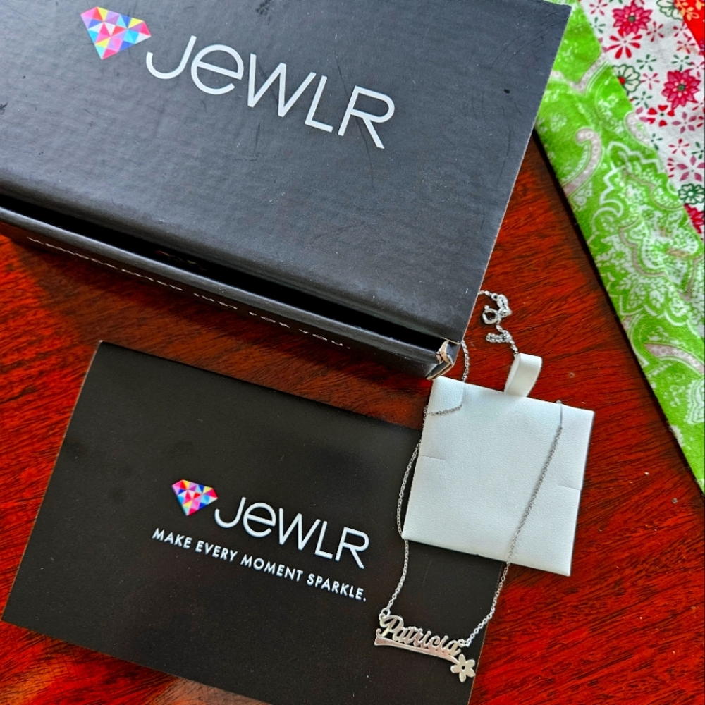 Silver necklace with personalized name.